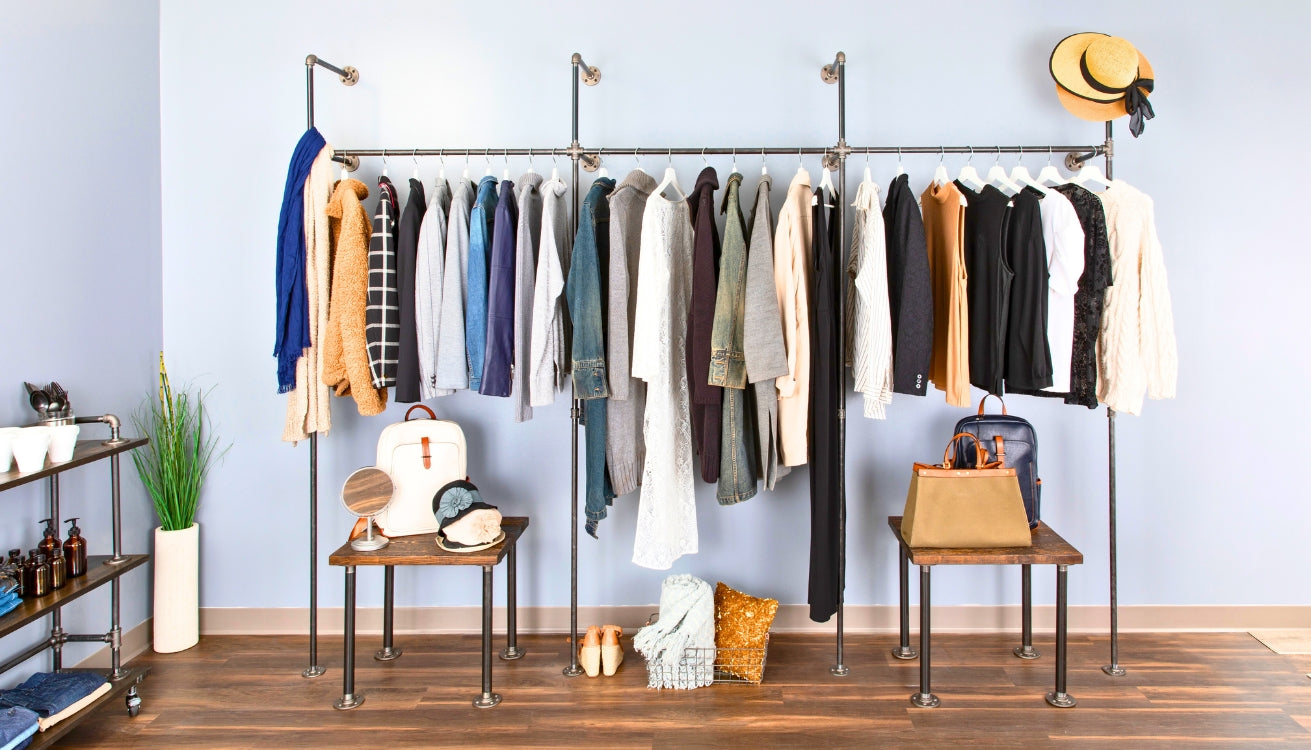 Bright and stylish bedroom featuring industrial pipe clothing racks for a perfect bedroom refresh, showcasing organized and chic storage solutions.