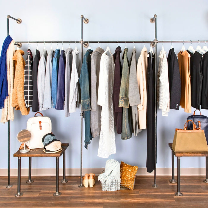 Bright and stylish bedroom featuring industrial pipe clothing racks for a perfect bedroom refresh, showcasing organized and chic storage solutions.