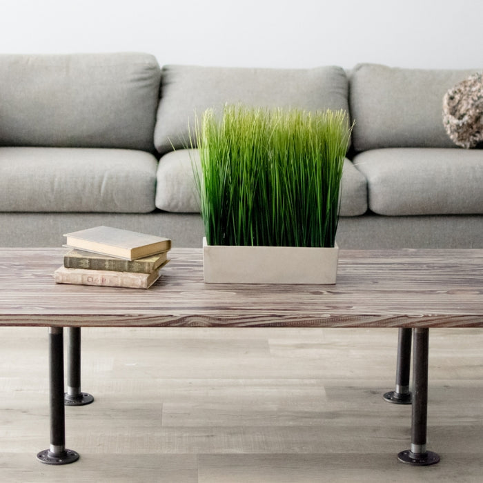 Minimalist living room featuring a pipe furniture coffee table, grey sofa, and modern decor elements, highlighting industrial pipe furniture style.