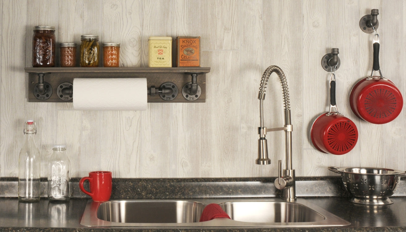 Innovative kitchen hacks featuring a PIPE DECOR® shelf and hooks holding kitchen essentials above a sink, blending functionality with industrial style.