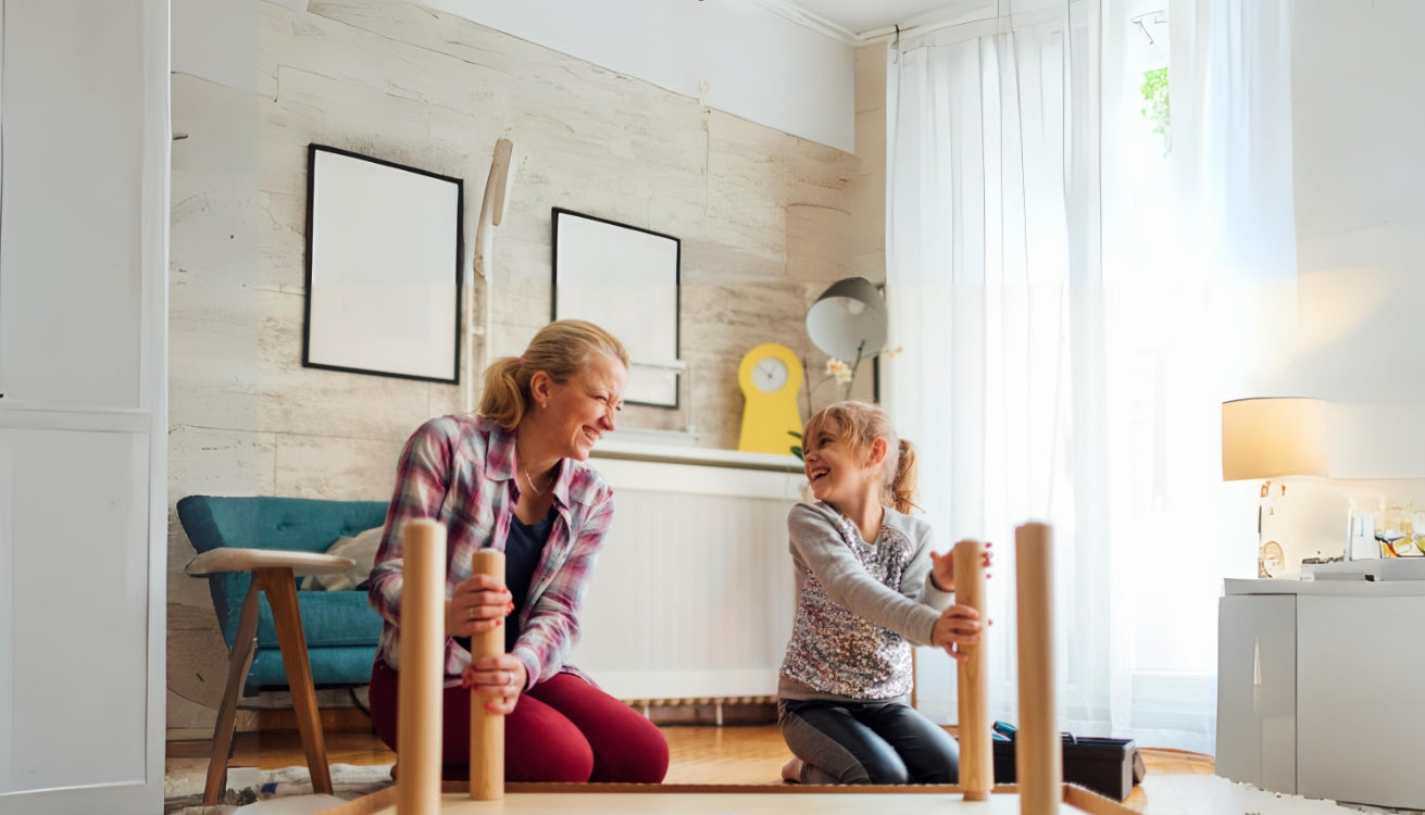 Image of a mother and daughter laughing together as they work on a DIY furniture project at home, celebrating Mother's Day by creating memories.