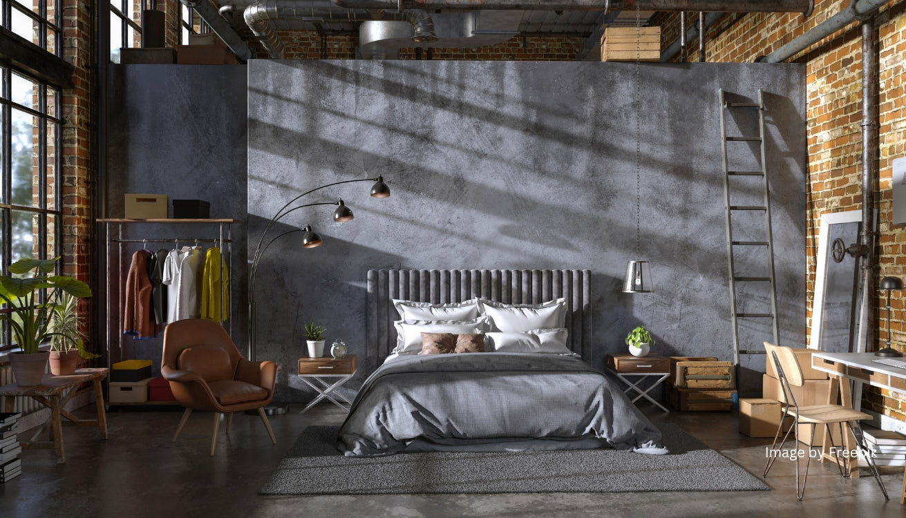 Stylish street style bedroom with exposed brick walls, a modern bed setup, and sleek pipe furniture, including a clothing rack and industrial decor accents.