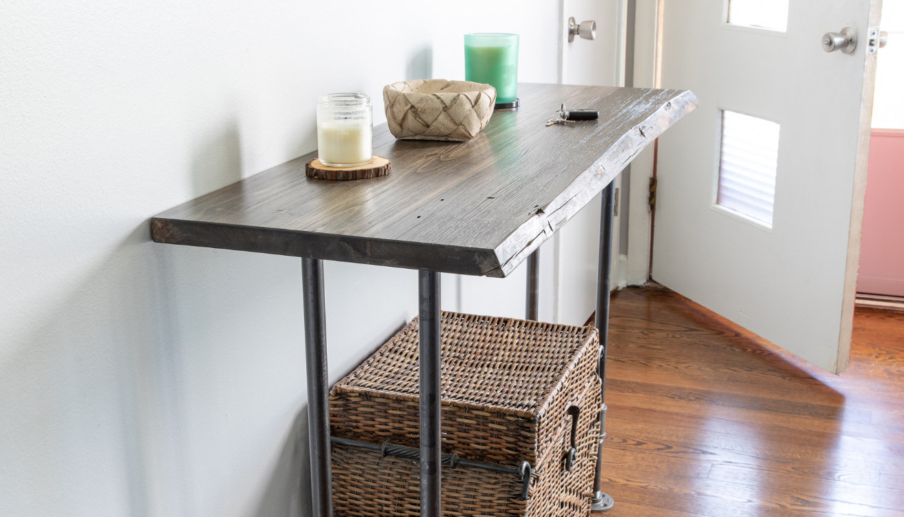 Industrial-inspired entryway showcasing functional pipe furniture: coat rack, shoe rack, console table, bench, shelving, umbrella stand, light fixtures, plant stand, and key holder by PIPE DECOR