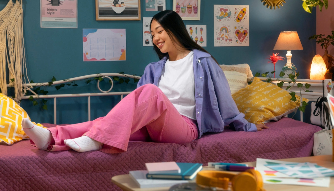 Image of a college student enjoying her time in here dorm room decorated with pipe furniture. 