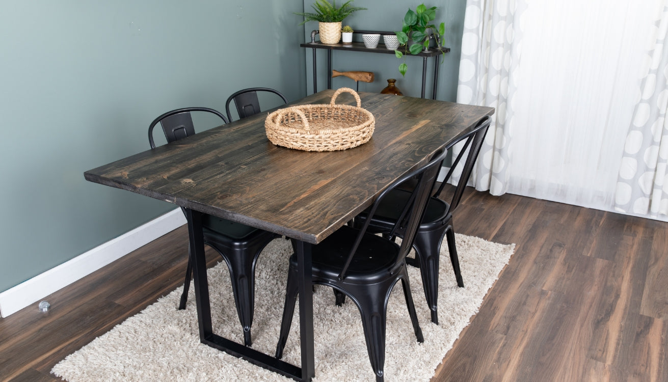 A dining table with natural wood top and skyline table legs from PIPE DECOR®