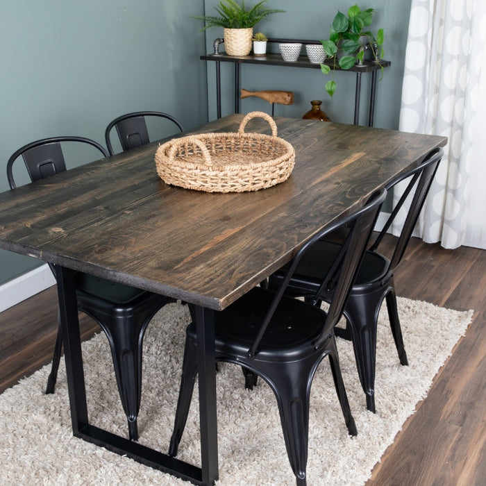 A dining table with natural wood top and skyline table legs from PIPE DECOR®