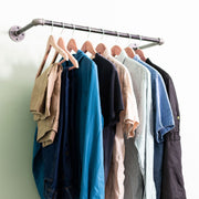 Image of pipe clothing rack hanging on wall
